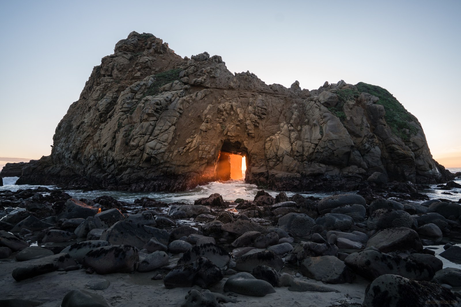 Glowing Rock Shelter on a Coastal Beach Wallpaper — Nature wallpaper