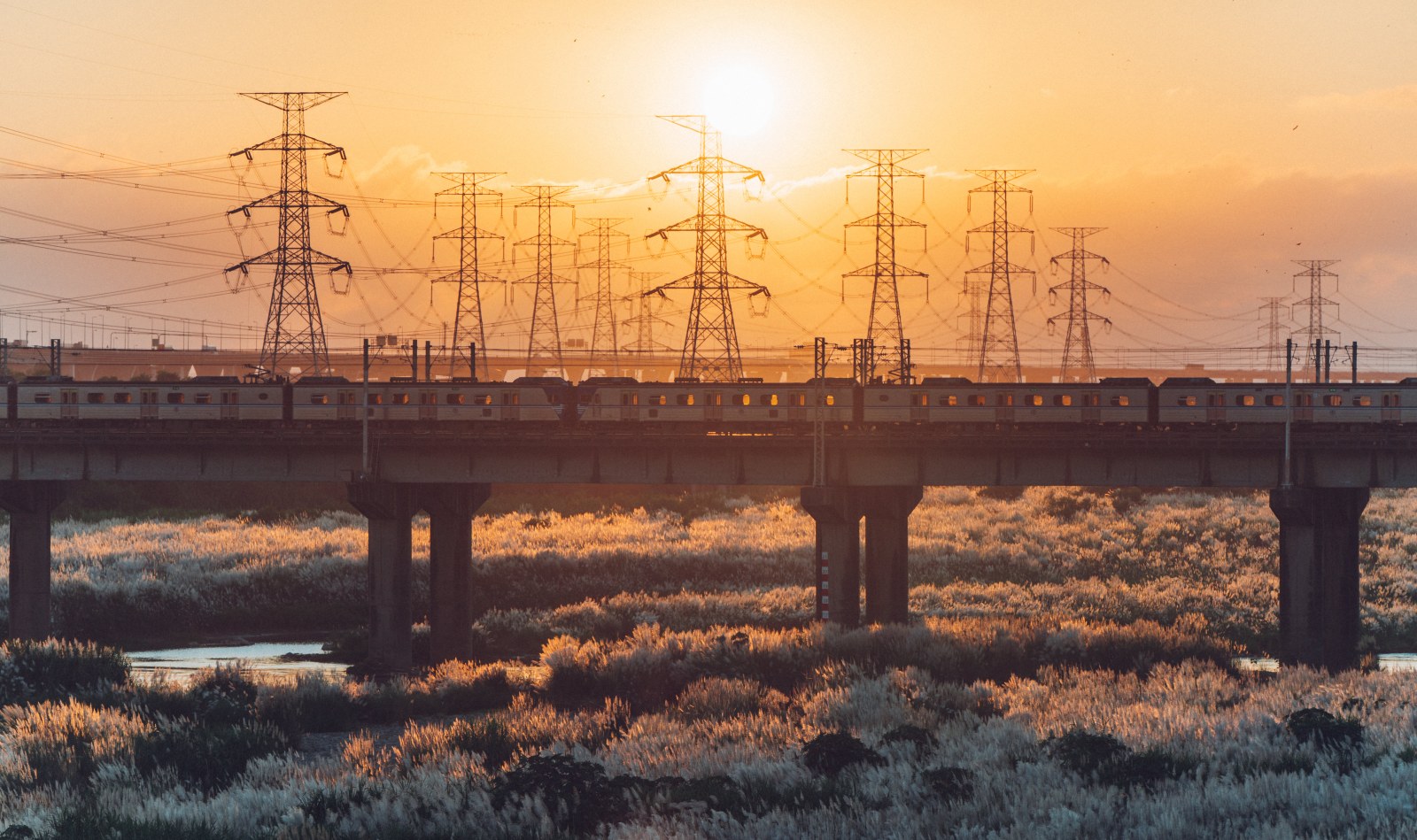 Commuter Train Crossing a Sunset Bridge — Anime wallpaper