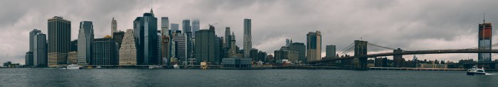 Lower Manhattan skyline and the Brooklyn Bridge seen across the water on an overcast day
