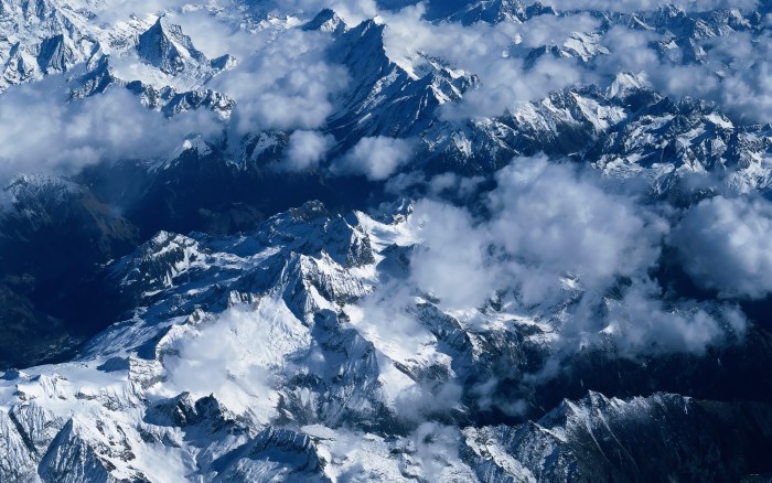 Snowy Mountain Peaks Through Clouds Wallpaper — Nature wallpaper