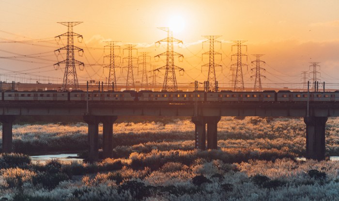 Commuter Train Crossing a Sunset Bridge — Anime wallpaper