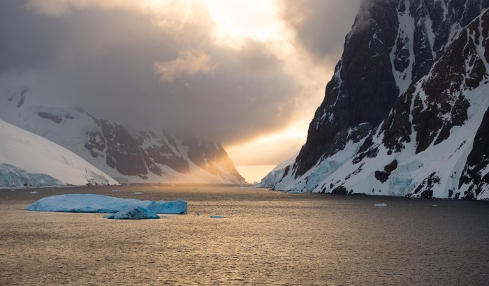 Sunlight Between Snowy Fjord Cliffs Wallpaper — Nature wallpaper