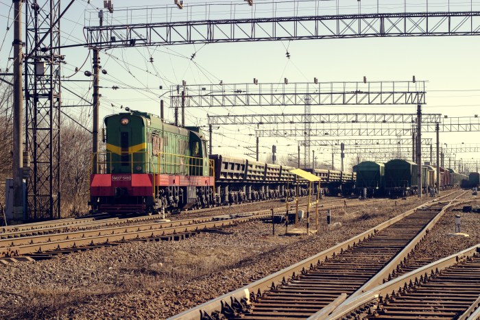 Green Diesel Locomotive in a Freight Yard — Trains wallpaper